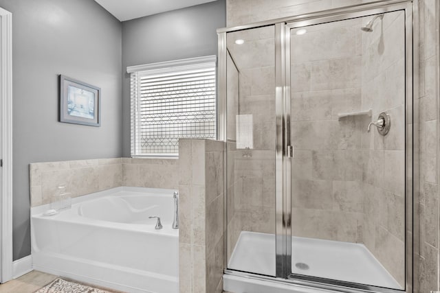 bathroom with separate shower and tub