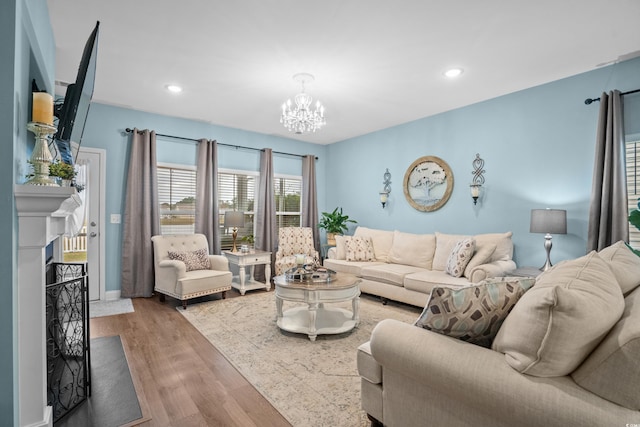 living room with hardwood / wood-style floors and a notable chandelier