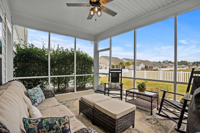 sunroom with ceiling fan and wood ceiling