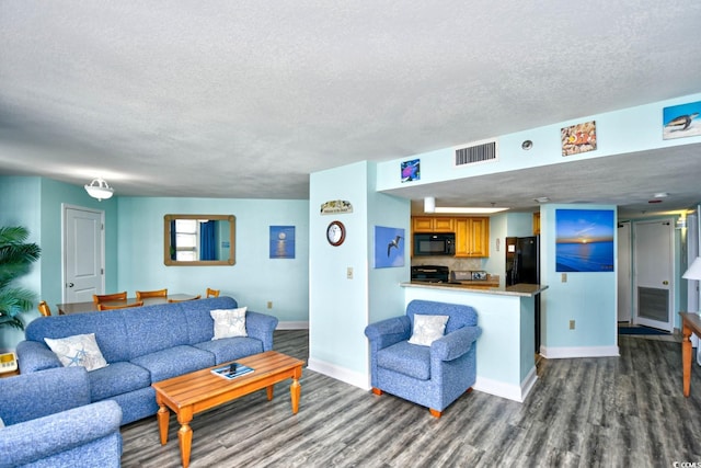 living room with wood-type flooring and a textured ceiling