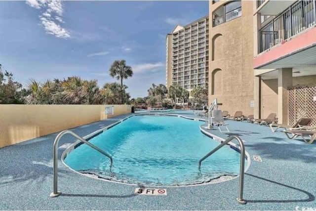 view of swimming pool with a patio area