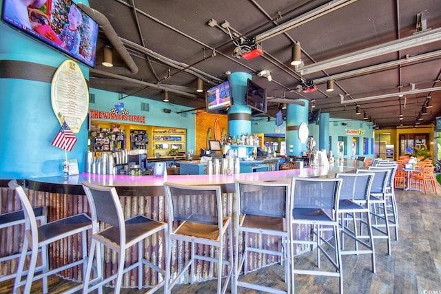 bar with wood-type flooring