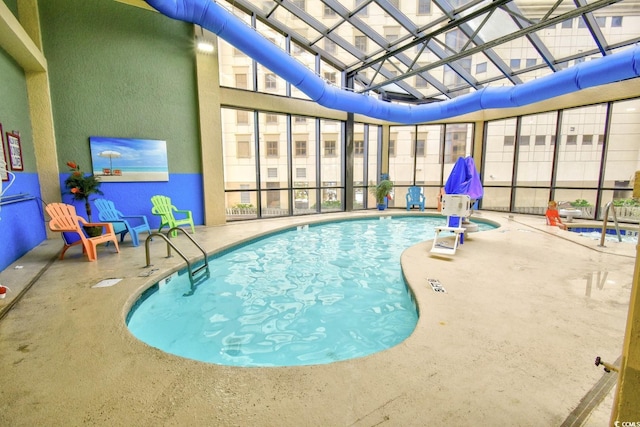 view of swimming pool with a water slide and a patio