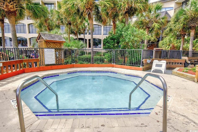 view of swimming pool featuring a community hot tub