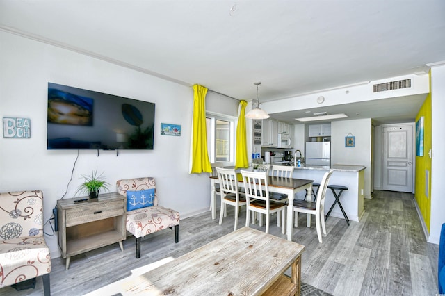 dining area featuring light hardwood / wood-style floors and sink