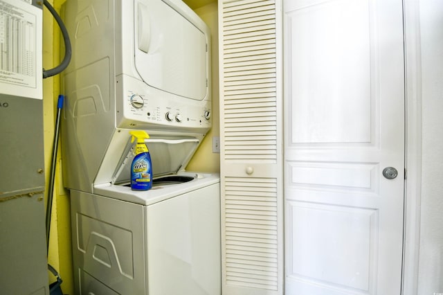 washroom featuring stacked washer / dryer