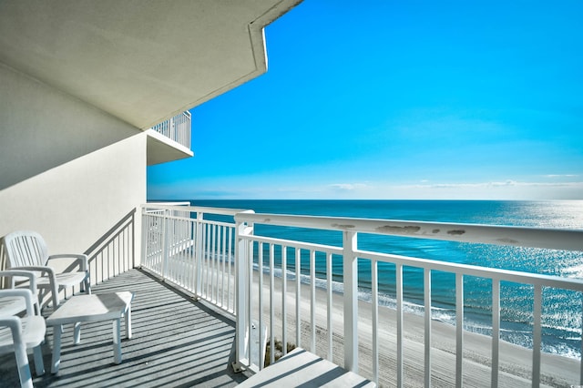 balcony featuring a water view and a view of the beach