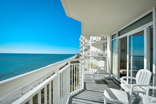 balcony with a view of the beach and a water view