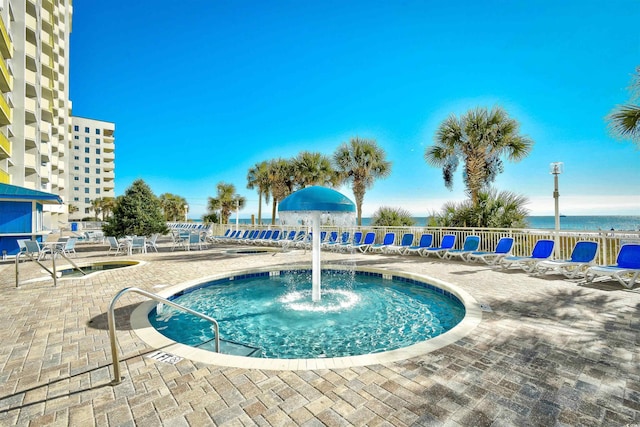 view of swimming pool with a water view