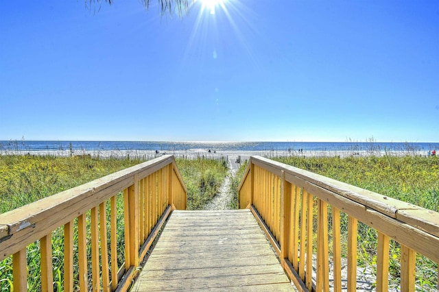 surrounding community with a view of the beach and a water view