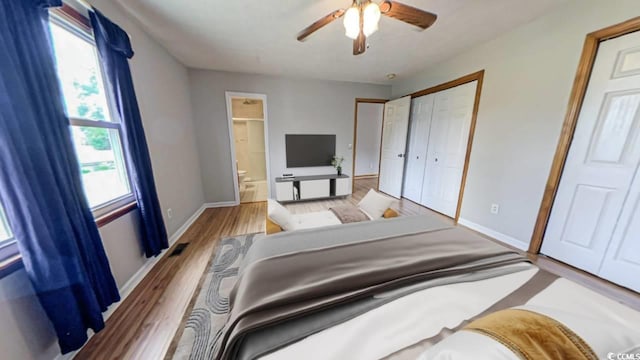 bedroom with ceiling fan, a closet, ensuite bath, and light hardwood / wood-style flooring