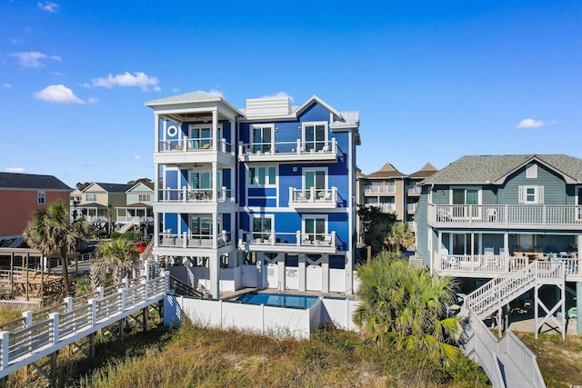 219 S Seaside Dr, Surfside Beach, SC 29575 - back of house featuring a fenced backyard and a balcony