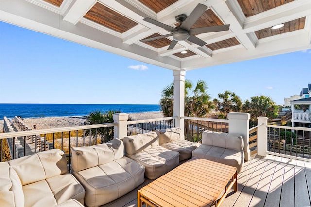 wooden terrace with a view of the beach, a water view, and ceiling fan