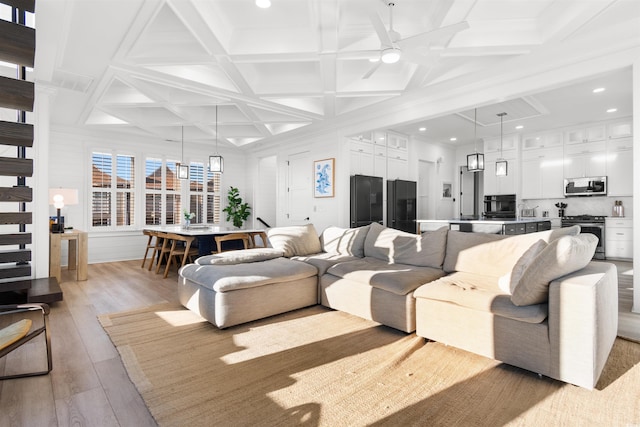 219 S Seaside Dr, Surfside Beach, SC 29575 - living room with coffered ceiling, light wood-style flooring, recessed lighting, ceiling fan, and beamed ceiling