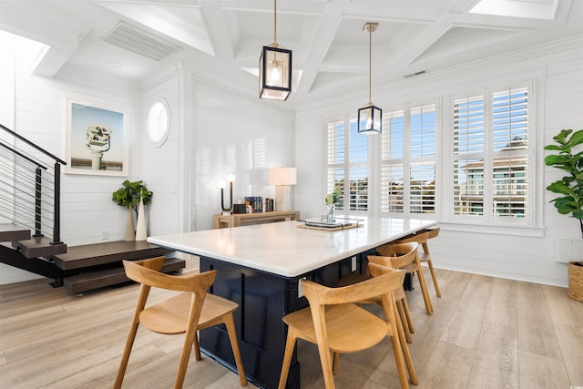 219 S Seaside Dr, Surfside Beach, SC 29575 - dining space featuring plenty of natural light, light wood finished floors, beam ceiling, stairs, and coffered ceiling