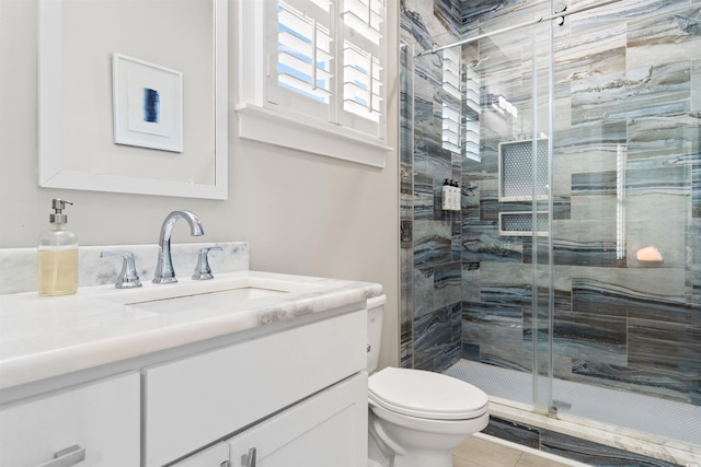 bathroom with tile patterned flooring, vanity, toilet, and a shower with door