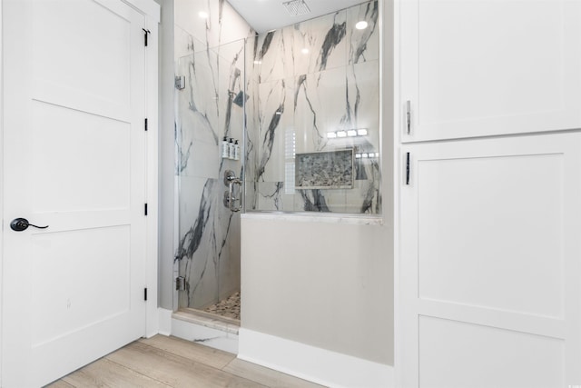 219 S Seaside Dr, Surfside Beach, SC 29575 - bathroom with a marble finish shower and wood finished floors