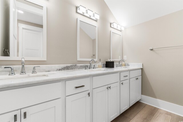 219 S Seaside Dr, Surfside Beach, SC 29575 - full bathroom featuring double vanity and wood finished floors