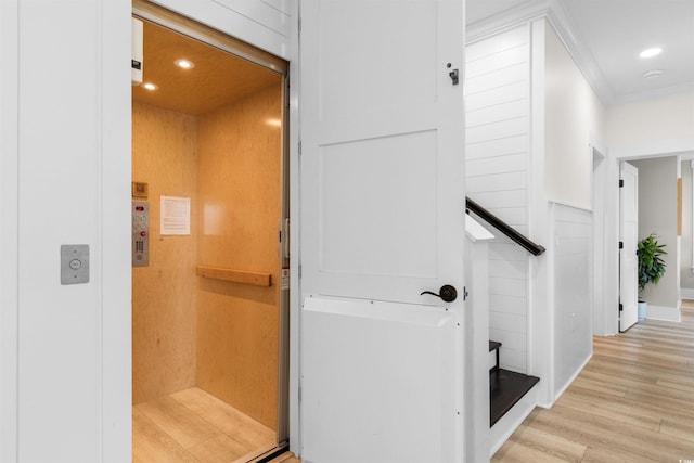 219 S Seaside Dr, Surfside Beach, SC 29575 - hallway featuring elevator, light wood-style floors, crown molding, and recessed lighting