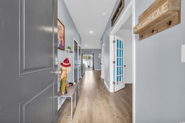 hall with light hardwood / wood-style flooring