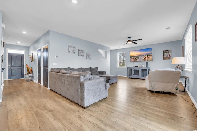 living room featuring ceiling fan and light hardwood / wood-style flooring