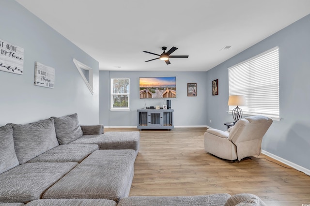 living room featuring ceiling fan and light wood-type flooring