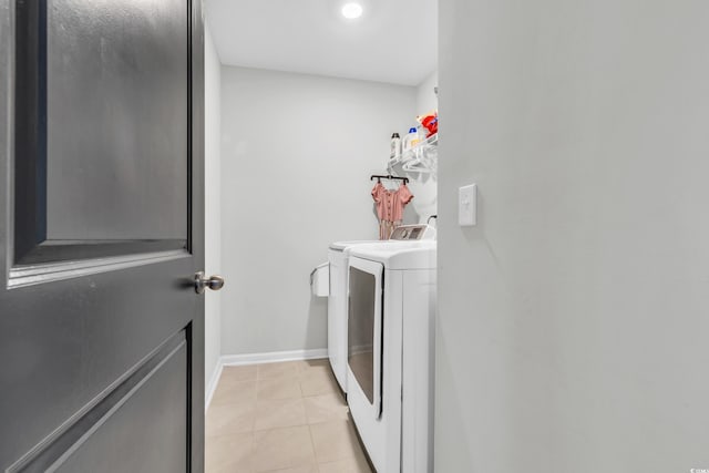 laundry room featuring washer and dryer and light tile patterned flooring