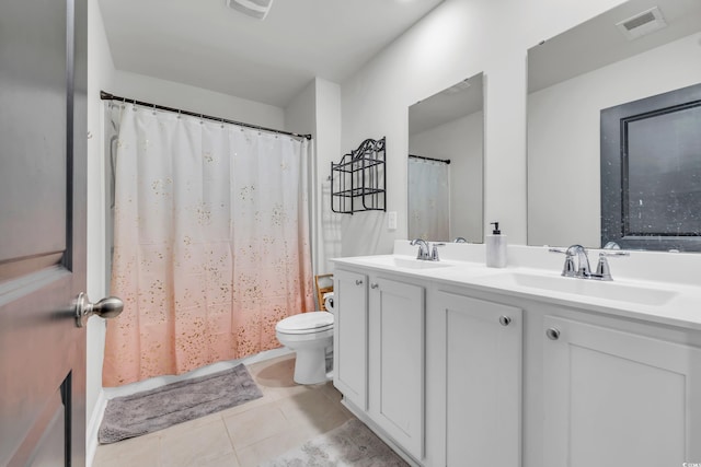 bathroom with tile patterned flooring, vanity, and toilet