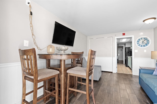 dining area with radiator and hardwood / wood-style flooring