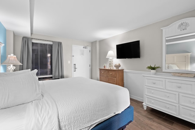 bedroom with dark hardwood / wood-style floors