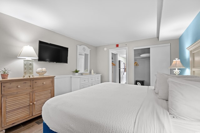 bedroom with hardwood / wood-style floors and a closet