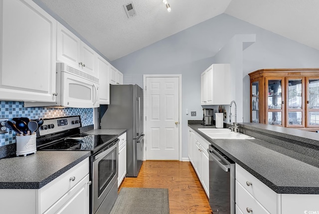 kitchen featuring backsplash, white cabinetry, sink, and stainless steel appliances