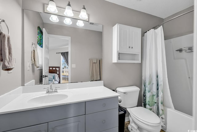 full bathroom featuring toilet, vanity, and shower / tub combo with curtain