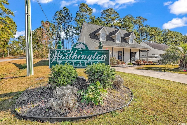 community sign featuring a yard