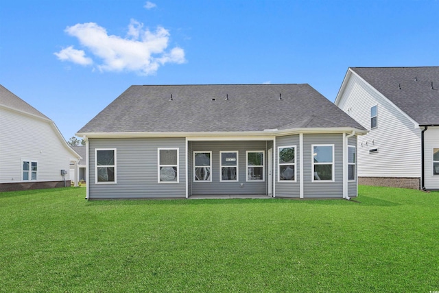 rear view of property with a lawn