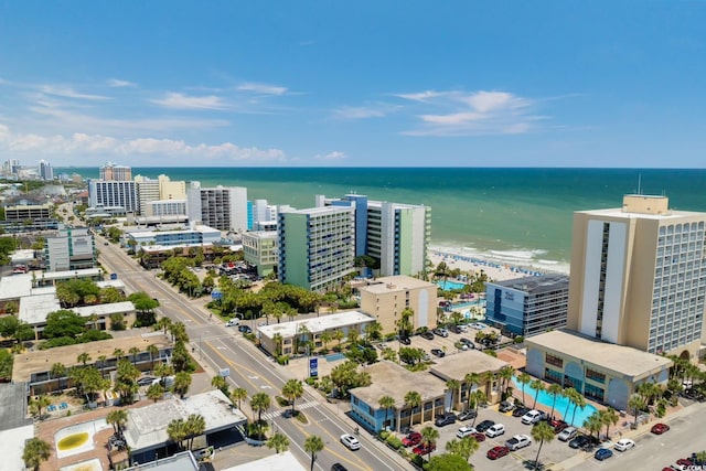 birds eye view of property with a view of city and a water view