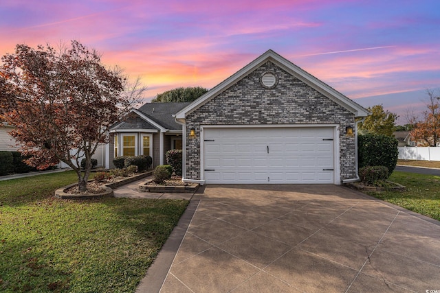 single story home featuring a garage and a lawn