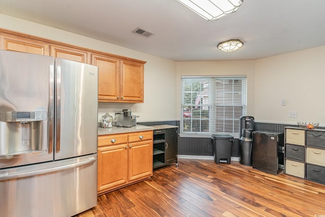 kitchen with fridge, stainless steel fridge with ice dispenser, and dark hardwood / wood-style floors