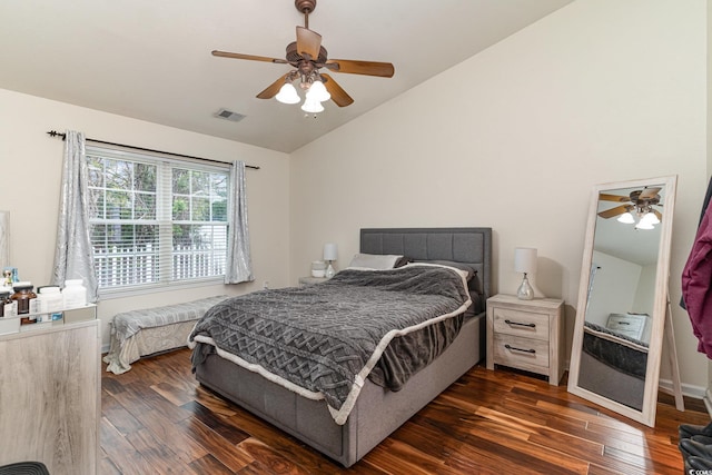 bedroom featuring dark hardwood / wood-style flooring, vaulted ceiling, and ceiling fan