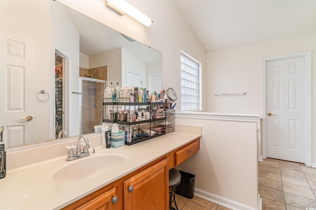 bathroom with tile patterned flooring, vanity, a shower with door, and vaulted ceiling