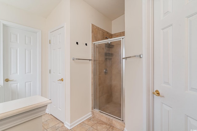 bathroom featuring tile patterned floors and an enclosed shower