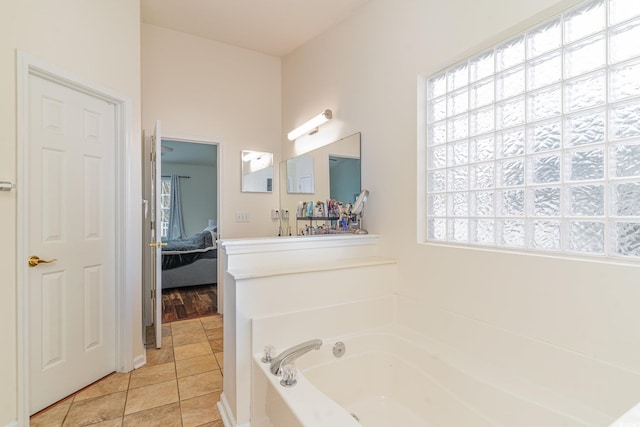 bathroom featuring tile patterned flooring and a bathing tub