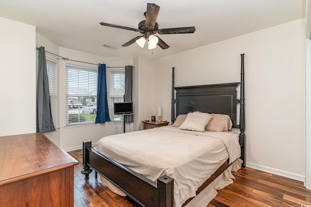 bedroom with ceiling fan and dark hardwood / wood-style floors