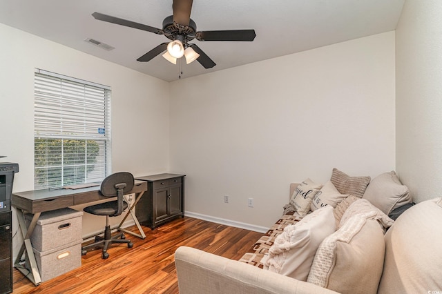 home office with hardwood / wood-style flooring and ceiling fan