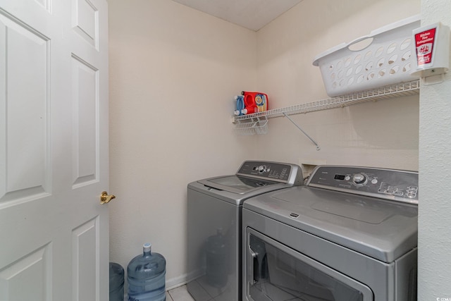 washroom featuring tile patterned flooring and separate washer and dryer