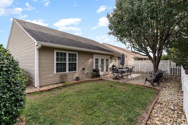 back of house featuring a lawn, french doors, and a patio