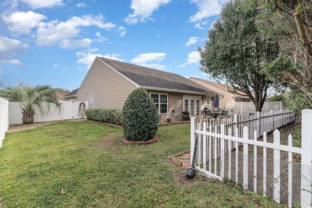 view of property exterior featuring a lawn and french doors