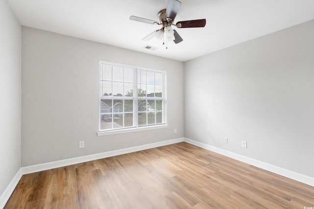 empty room with light wood-type flooring and ceiling fan