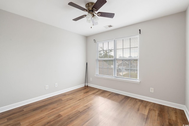 spare room with hardwood / wood-style flooring and ceiling fan