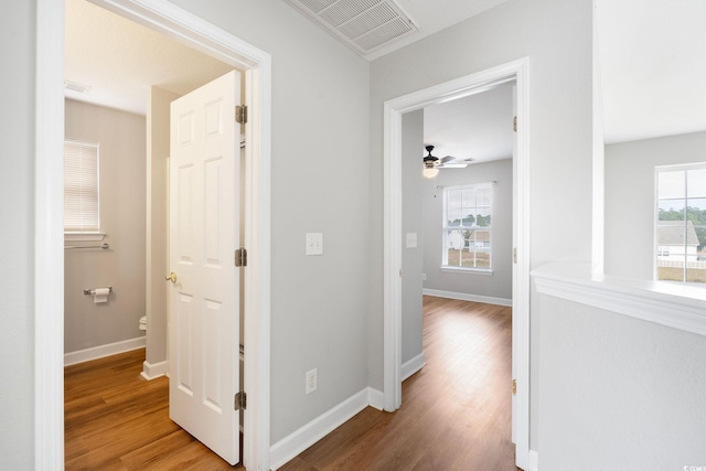 corridor with hardwood / wood-style floors